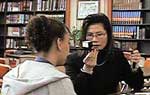 Photo: A Gemstone doctor performs a vision screening test.